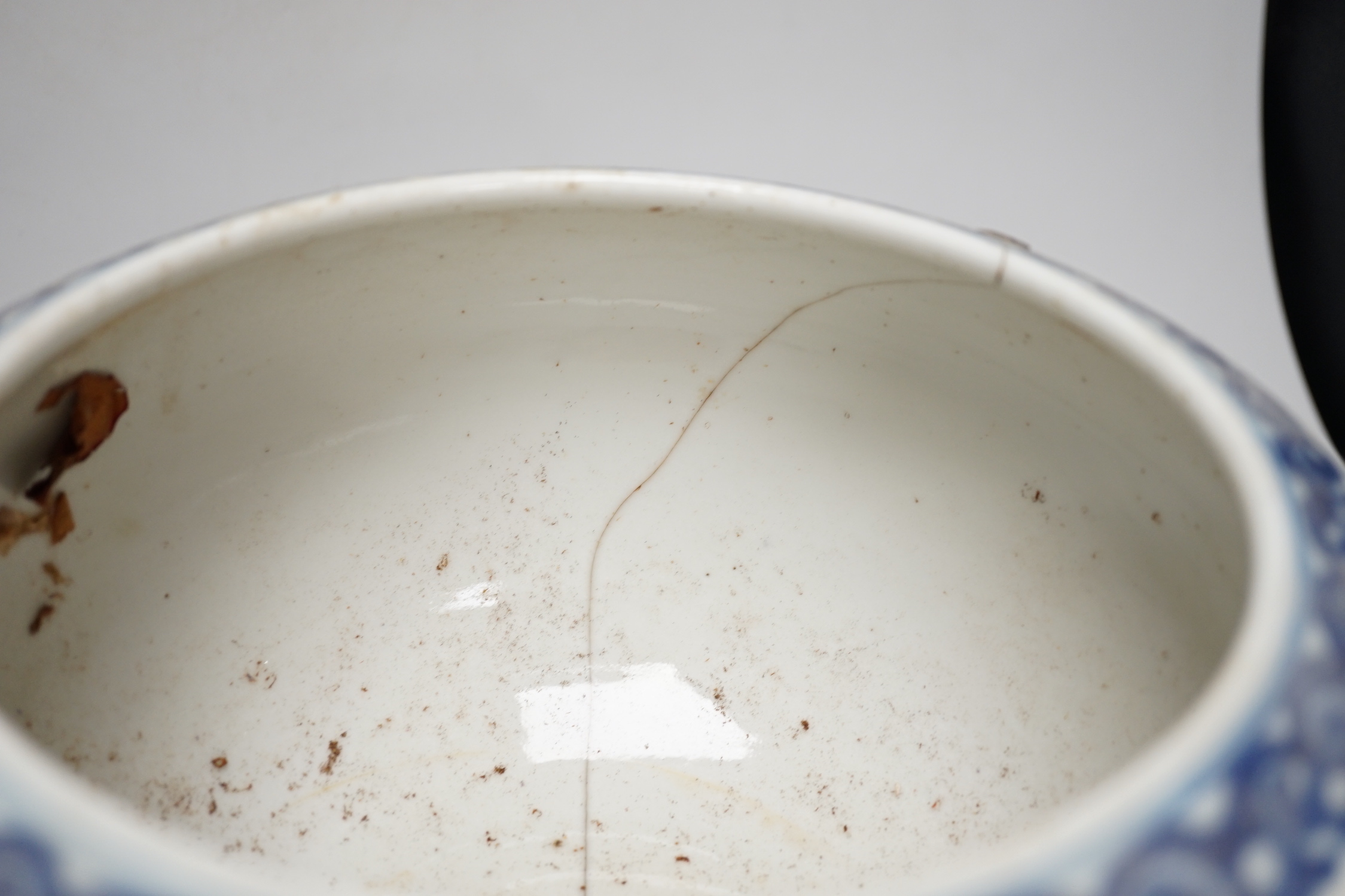 A 19th century Chinese blue and white ‘eight immortals’ alms bowl, apocryphal Qianlong seal mark, 25cm diameter (a.f.), wood stand
